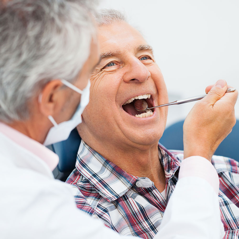 Emergency dentist examining patient in Downey
